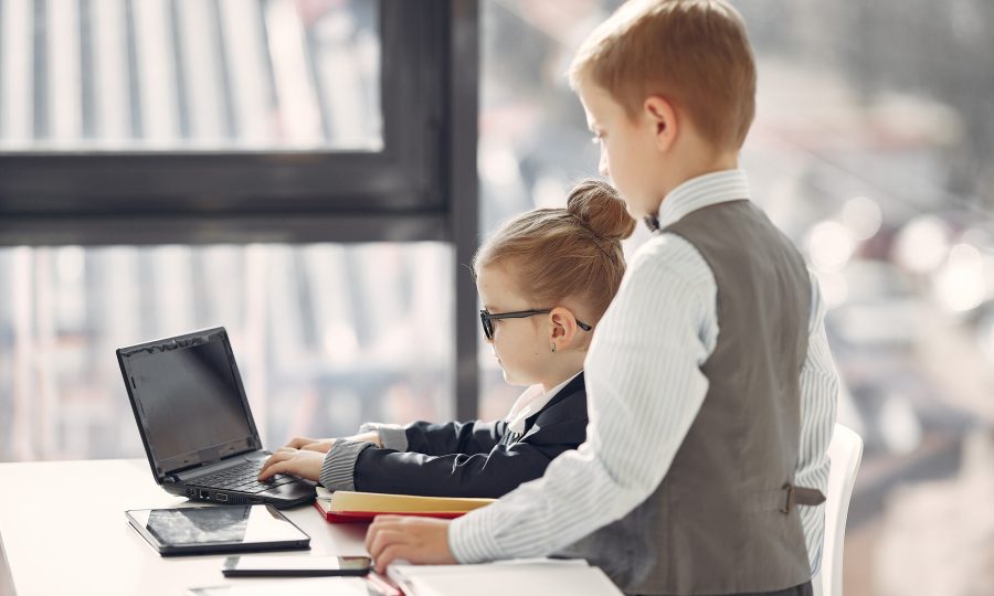Business theme. Children in a business style. Kid with a laptop.